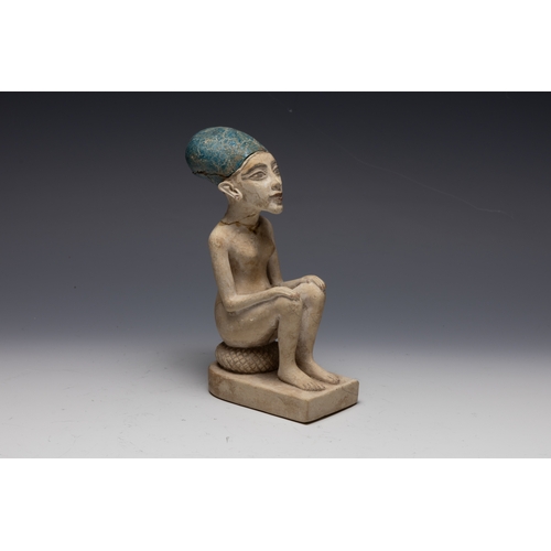 259 - An Egyptian Style Figure of a Seated Man.

H: Approximately 15.8cm