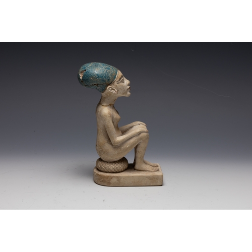 259 - An Egyptian Style Figure of a Seated Man.

H: Approximately 15.8cm