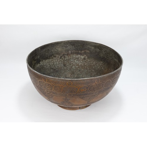 164 - An Islamic Middle Eastern Large Copper Bowl with Intricate Carving of Floral Patterns and Islamic Ca... 