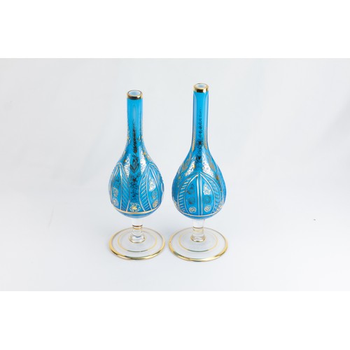 179 - A Pair of Islamic Blue Glass Rose Water Sprinklers Depicting Floral Patterns.

H: Approximately 28cm