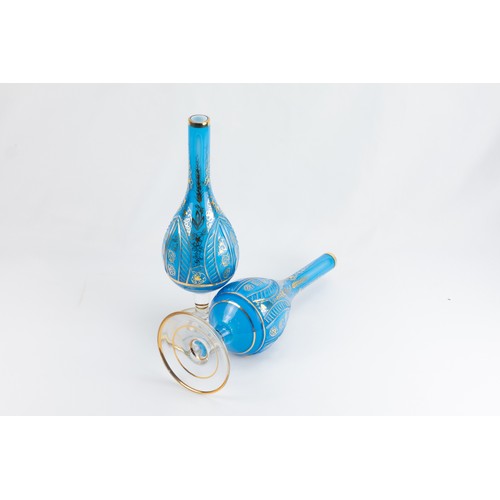 179 - A Pair of Islamic Blue Glass Rose Water Sprinklers Depicting Floral Patterns.

H: Approximately 28cm