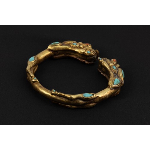 92 - A Chinese Tibetan Gilt Bangle Depicting 2 Lions with Turquoise Coral.

D: Approximately 8cm