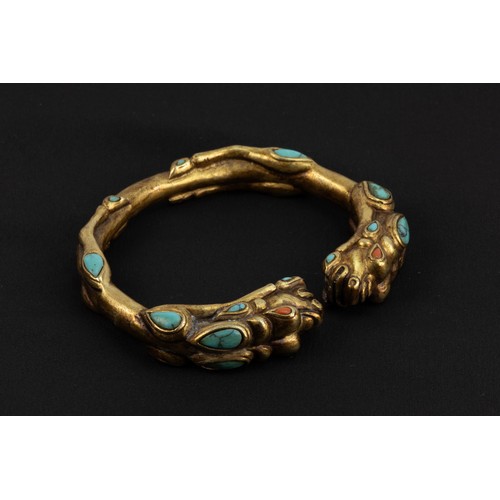 92 - A Chinese Tibetan Gilt Bangle Depicting 2 Lions with Turquoise Coral.

D: Approximately 8cm