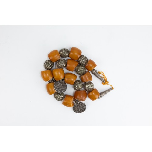 36 - A Tribal Yemeni Amber and Silver Beads Necklace with Islamic Coins from the 19th Century.

211g