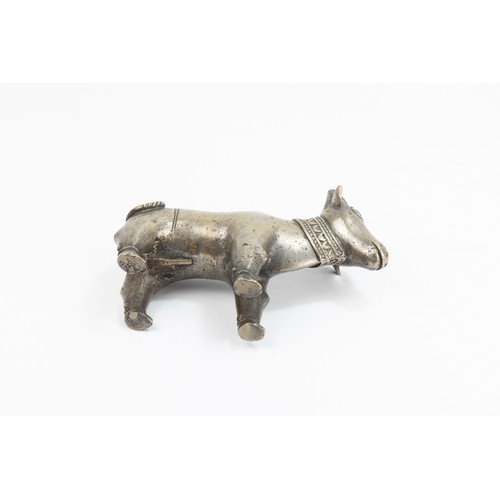 124 - An Indian Mughal Bronze Figure of a Cow.

L: Approximately 15.2cm