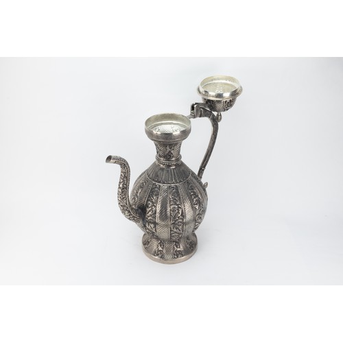 128 - An Indian White Metal Ewer Decorated with Intricate Carvings of Floral Patterns.

H: Approximately