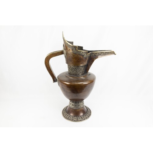 261 - A Tibetan Large Copper Monk's Cap Ewer Decorated with White Metal from the 19th Century.

H: Approxi... 