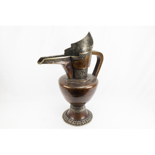 261 - A Tibetan Large Copper Monk's Cap Ewer Decorated with White Metal from the 19th Century.

H: Approxi... 