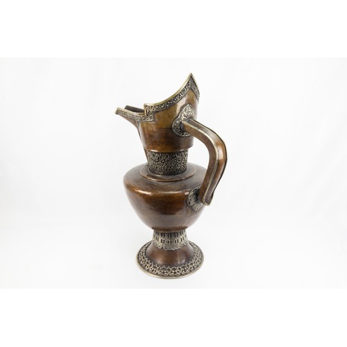 261 - A Tibetan Large Copper Monk's Cap Ewer Decorated with White Metal from the 19th Century.

H: Approxi... 