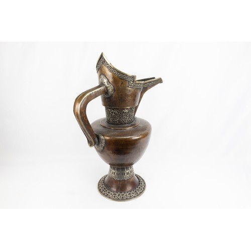 261 - A Tibetan Large Copper Monk's Cap Ewer Decorated with White Metal from the 19th Century.

H: Approxi... 