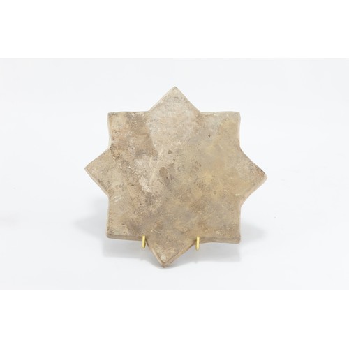 219 - An Islamic Kashan Moulded Tile in the Shape of a Star from the 14th Century.

L: Approximately 20.5c... 