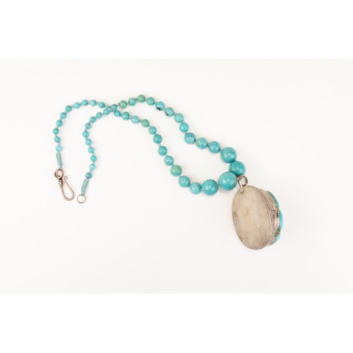 60 - A Tibetan Turquoise Necklace with a Silver Pendant from the Mid 20th Century.

L: Approximately 16.5... 