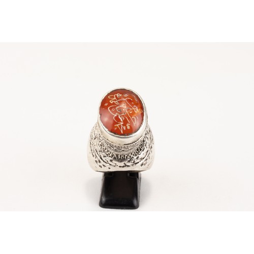 62 - An Islamic Tribal Turkman Silver Ring Decorated with Islamic Calligraphy in Carnelian from the Mid 2... 