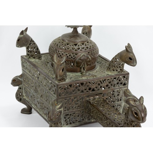 222 - An Islamic Bronze Incense Burner Decorated with Lion Heads and Silver Inlay & Intricate Openwork.

L... 