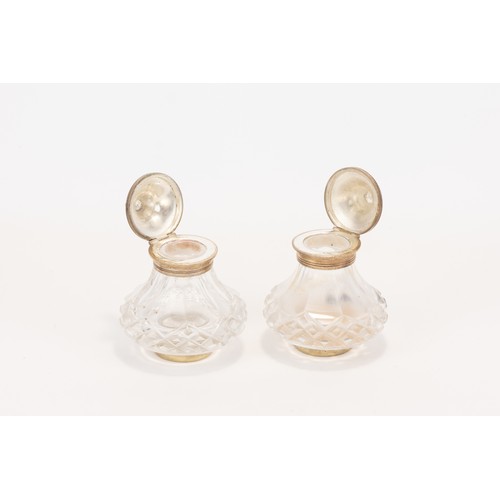 28 - **NO RESERVE**
A Pair of Crystal Inkwells with Silver Plated Lids.

H: Approximately 9cm