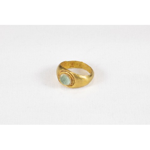 321 - An Ancient Roman Gold Ring with Glass Cabochon Circa 2nd Century A.D.

Internal D: 1.2cm
0.75g