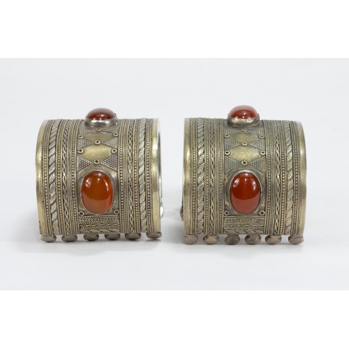 313 - A Pair of Tribal Afghan White Metal Gilded Bangles Decorated with Agate Stones.

282g