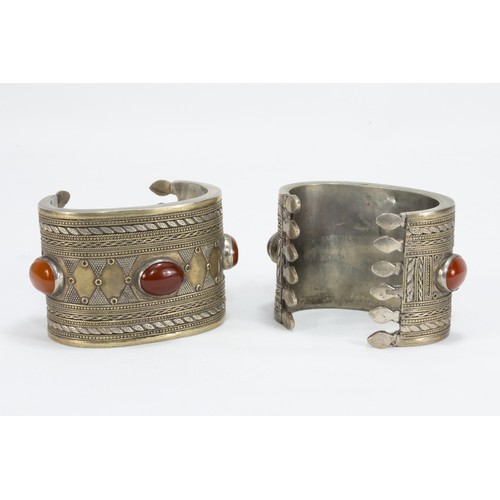 313 - A Pair of Tribal Afghan White Metal Gilded Bangles Decorated with Agate Stones.

282g