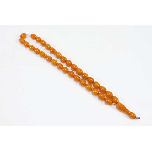 194 - An Islamic Single Strand Butterscotch Amber Prayer Beads Tasbih.

Half breaded length: Approximately... 