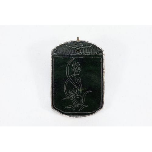 109 - A Chinese Dark Green Jade & Silver Pendant Depicting Floral Patterns.

H: Approximately 6.2cm