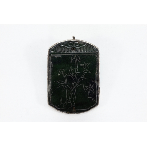 109 - A Chinese Dark Green Jade & Silver Pendant Depicting Floral Patterns.

H: Approximately 6.2cm