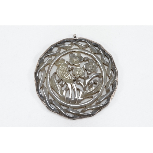 110 - A Chinese Carved Jade & Silver Round Pendant.

D: Approximately 5.5cm