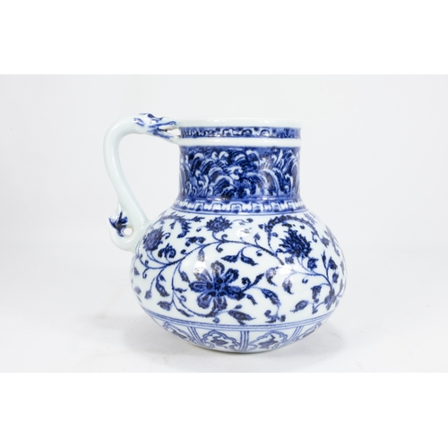 127 - A Chinese Blue & White Porcelain Jug Decorated with Floral Patterns 

H: Approximately 14.8cm