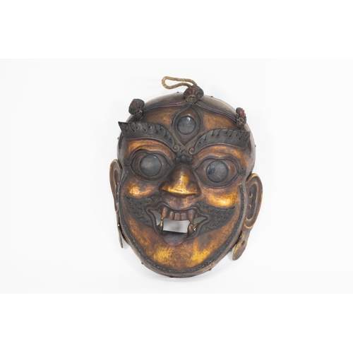 66 - A Tribal Tibetan Bronze Buddhist Wall Hanging Mask from the 19th Century.

Approximately 32.5cm x 27... 