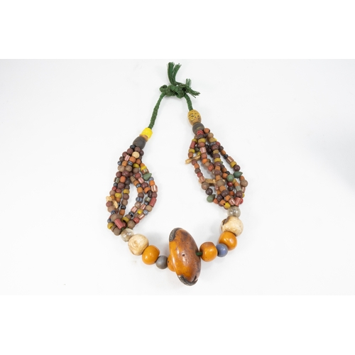 343 - A Large Tribal Moroccan Amber Coloured Beads Necklace.

Half breaded length: Approximately 35cm

410... 