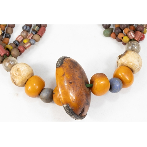 343 - A Large Tribal Moroccan Amber Coloured Beads Necklace.

Half breaded length: Approximately 35cm

410... 