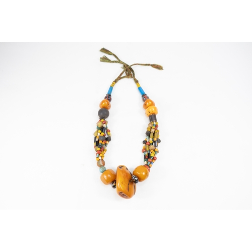 344 - A Large Tribal Moroccan Amber Coloured Beads Necklace.

Half breaded length: 34.5cm

388g