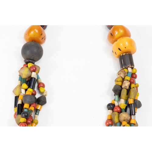 344 - A Large Tribal Moroccan Amber Coloured Beads Necklace.

Half breaded length: 34.5cm

388g