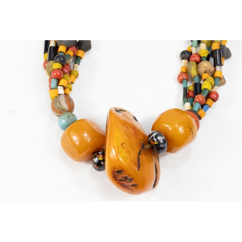 344 - A Large Tribal Moroccan Amber Coloured Beads Necklace.

Half breaded length: 34.5cm

388g