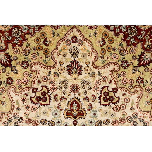 76 - An Islamic Turkish Silk Carpet with Silk Tassels  from the 20th Century.

Approximately 124cm x 77.5... 