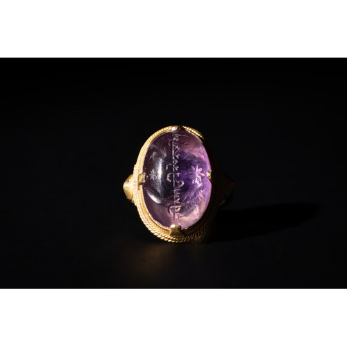 210 - An Amethyst Gold Ring with Islamic Inscription, Probably 12th-13th Century.

Ring Size: US8.25 UK18
... 