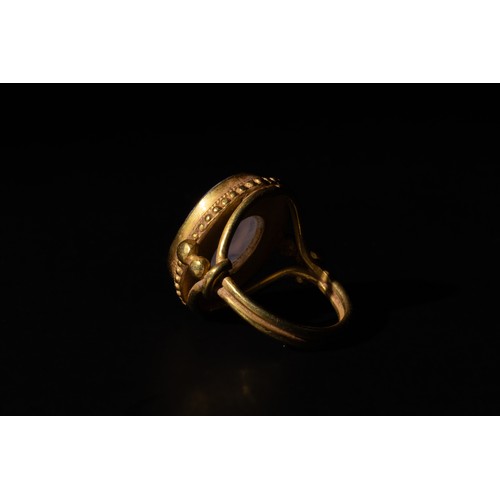 211 - A Gold Ring with White Chalcedony Agate Intaglio of the Head of a Roman Deity.

Ring Size: US7.25 UK... 