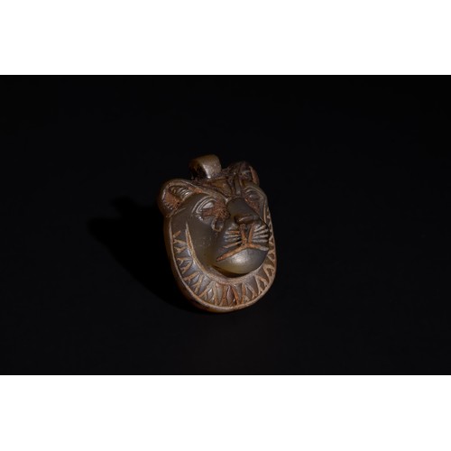 174 - An Egyptian Agate Amulet in the Form of a Pendant Lion Head, Early Ptolemaic Period, 400 B.C.

H: Ap... 