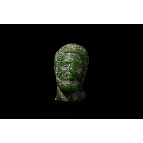 260 - A Roman Green Stone Bust of a Roman Deity/ Ruler, 2nd-3rd Century A.D.

H: Approximately 6.2cm

Prov... 