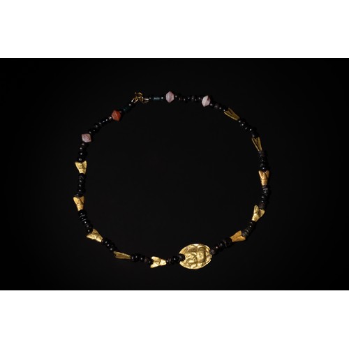 207 - An Egyptian Necklace Consisting of Different Period Beads & Amulets.

11.3g

Provenance: Part of a U... 