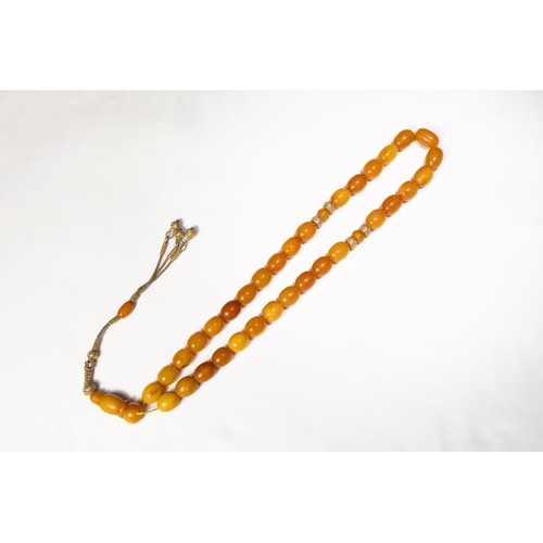 123 - An Islamic Butterscotch Amber Tasbih Prayer Beads with Silver Tassels. 

97g

Half breaded length: A... 