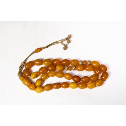 123 - An Islamic Butterscotch Amber Tasbih Prayer Beads with Silver Tassels. 

97g

Half breaded length: A... 