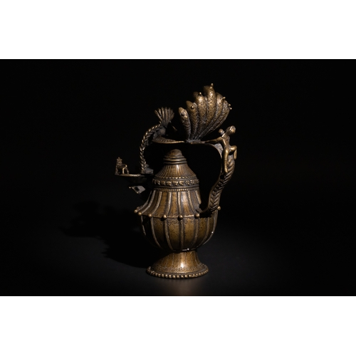 87 - An Indian Bronze Oil Lamp, Decorated with Mythical Beasts on the Bowl & a Man on the Handle.

H: App... 