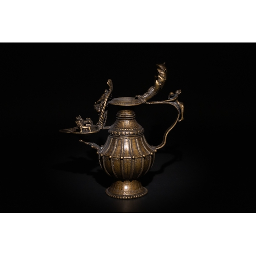 87 - An Indian Bronze Oil Lamp, Decorated with Mythical Beasts on the Bowl & a Man on the Handle.

H: App... 