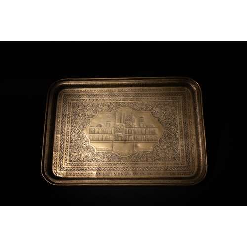 142 - An Islamic Qajar Brass Tray with Masjid Shah Engraved, 19th Century.

Approximately 46.3cm x 33cm