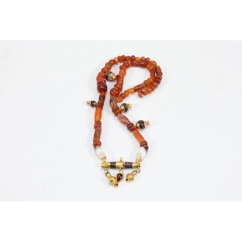 68 - A Roman Carnelian Necklace with a Gold Pendant Decorated with Garnet Stones from 625 BC- 476 AD.

Ha... 