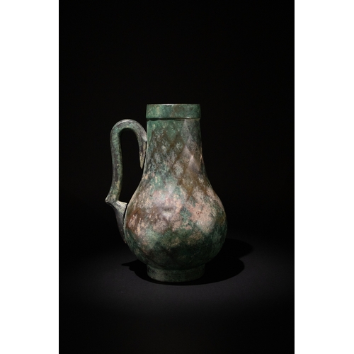 74 - A Late Sassanian - Early Islamic Period Bronze Ewer with Diamond-Shaped Cut Patterns, 6th-7th Centur... 