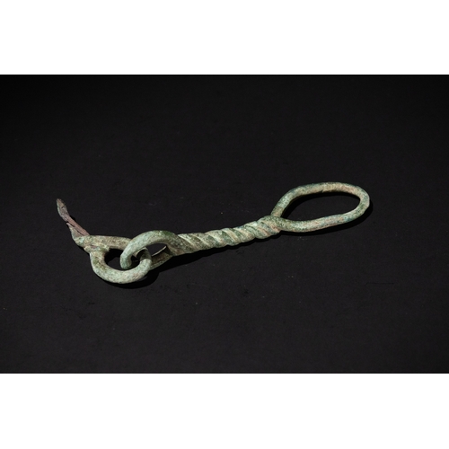 81 - A Luristani Bronze Horse Bit Twisted Loop, 1st Millennium B.C.

L: Approximately 17.5cm