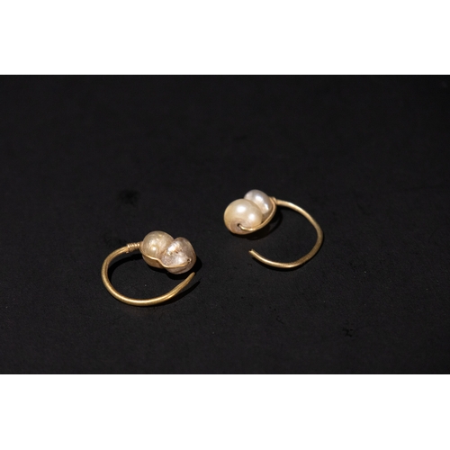 124 - A Pair of Islamic Gold Earrings with Pearls, 12th Century.

2.6g