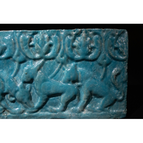 304 - An Islamic Kashan Turquoise Glazed Pottery Tile, 12th Century, Decorated with Felines.

Approximatel... 