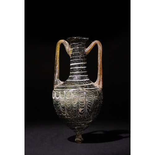 93 - An Eastern Mediterranean Core-Formed Glass Double-Handled Amphoriskos, 2nd - 1st Century B.C.

H: Ap... 